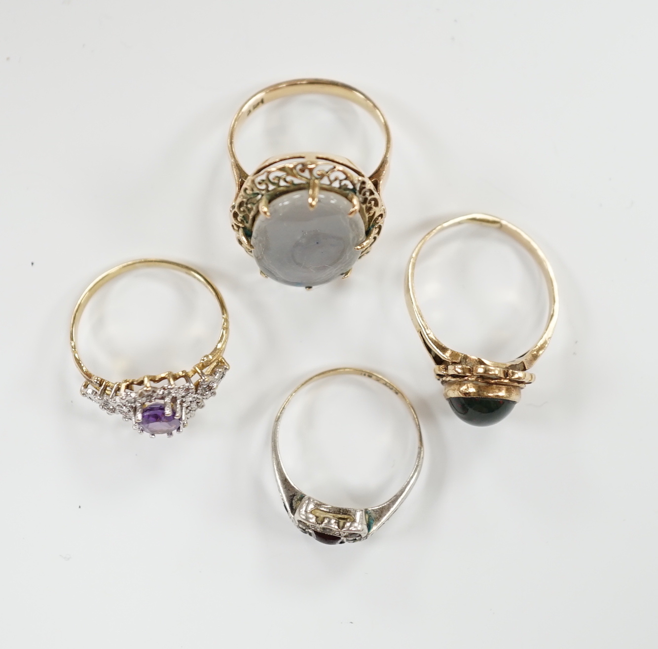 Two 9ct and gem set rings including cabochon bloodstone, a 14k and opal? doublet set ring and one other ring.